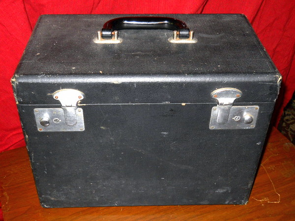 black box with two silver  hasps and a carry handle