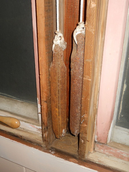 cast iron weights inside the window trim