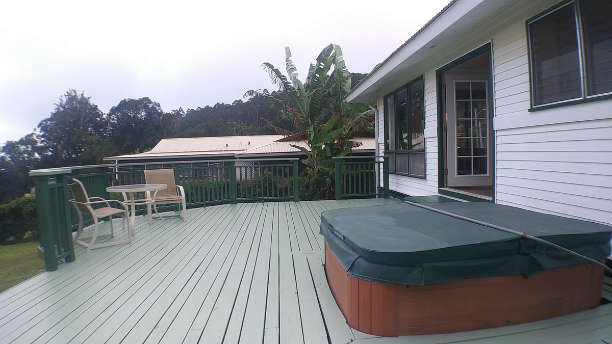 view of the hot tub with cover in back