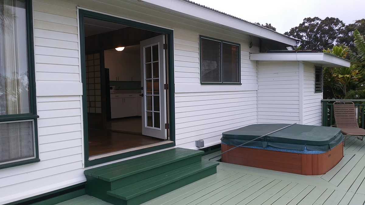 view of the hot tub with cover in back