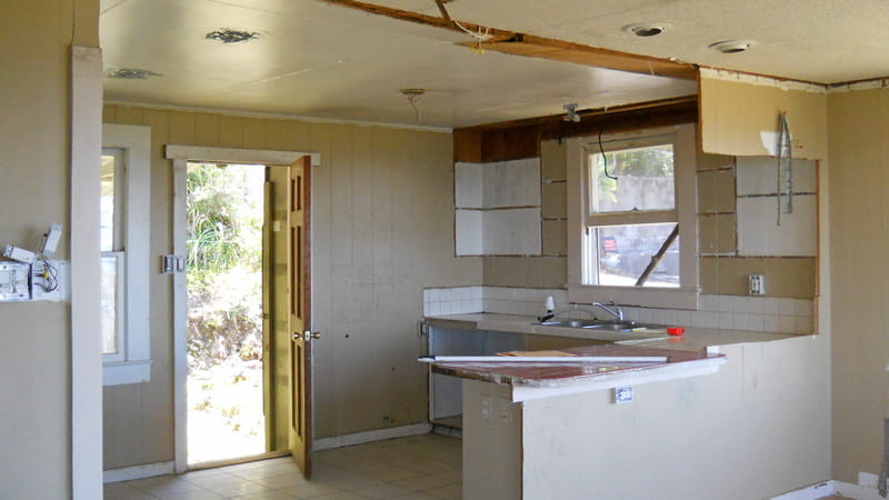 before picture of hacked out wall between kitchen and living room